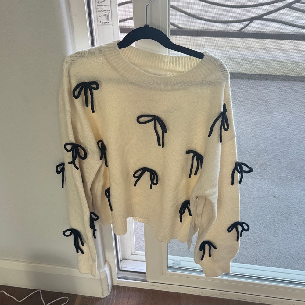 Elegant Cream Sweater with Black Bow Details
